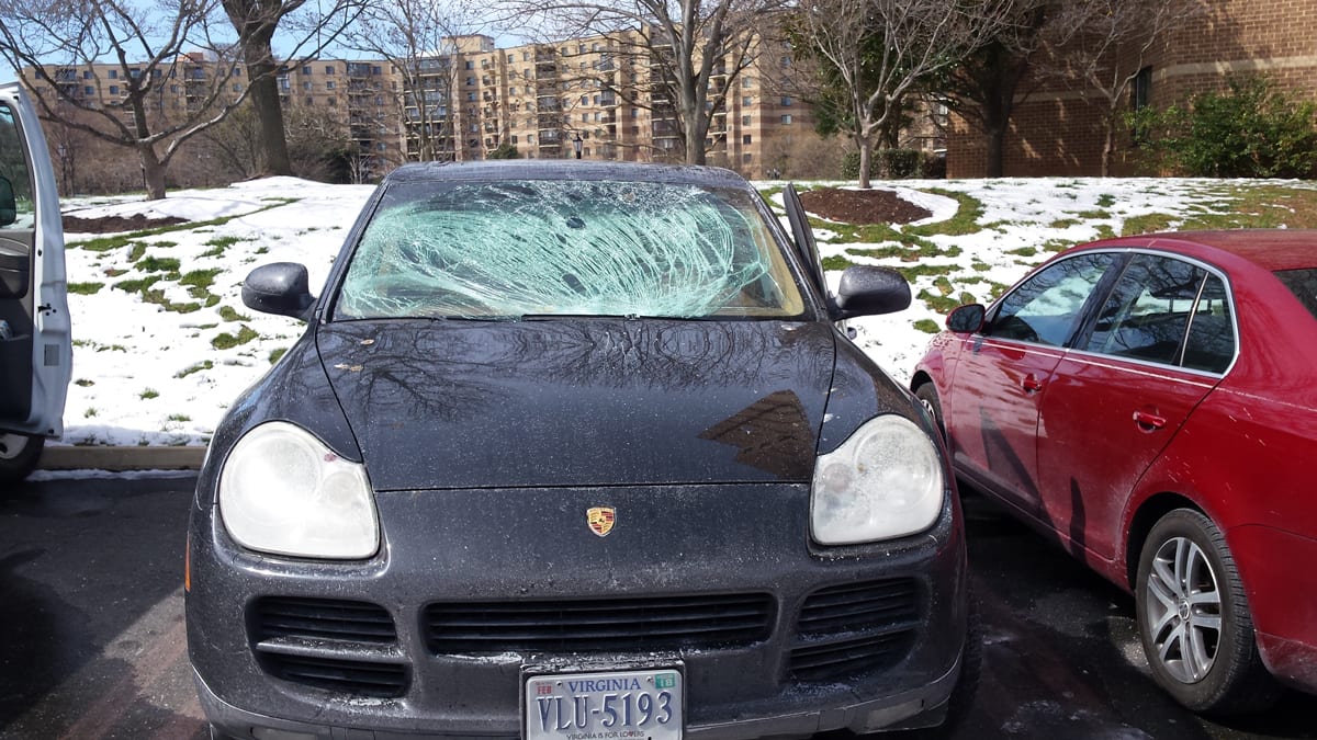 porsche with flying ice damage